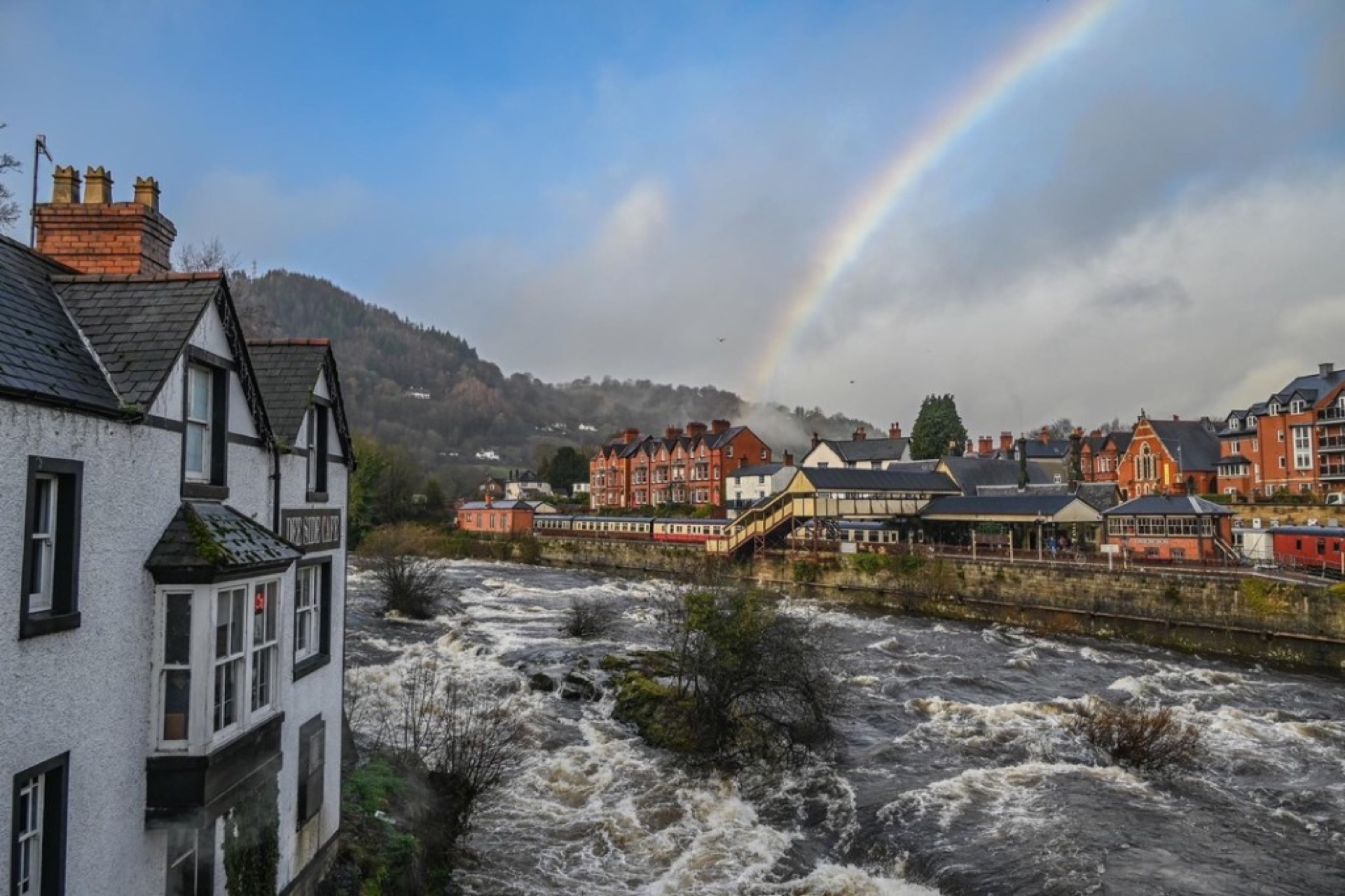 Wales river town with rainbow